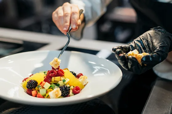 A plated dish being prepared